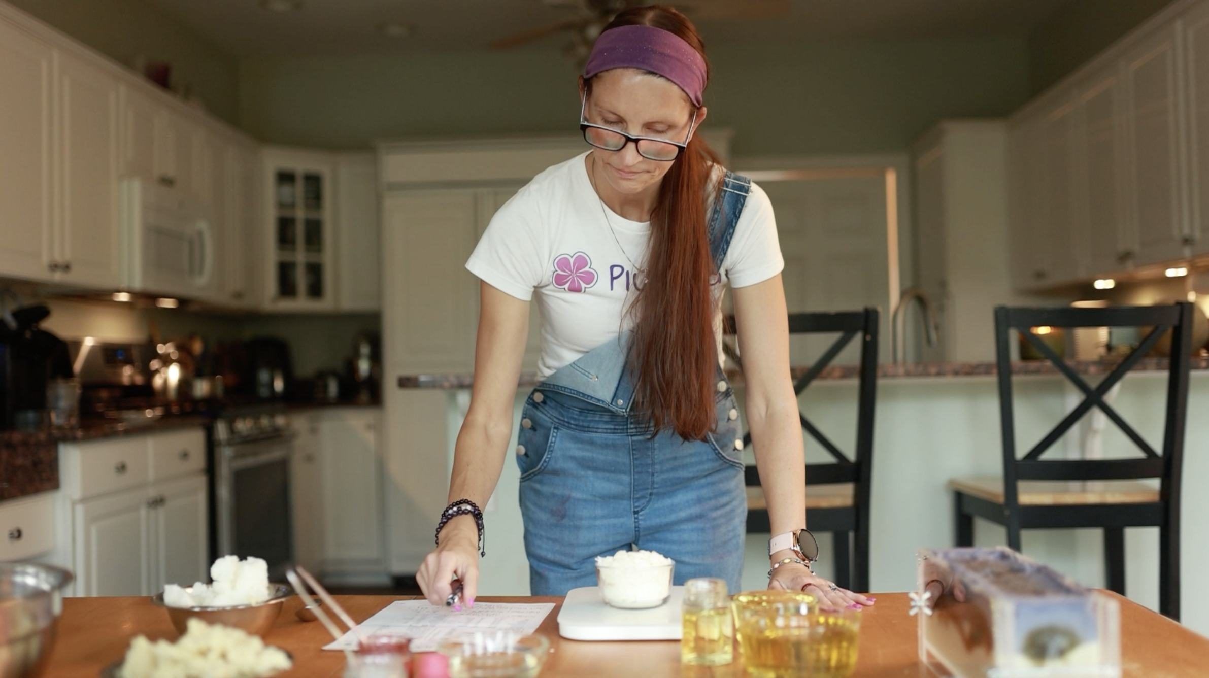 Allison Savino measuring ingredients for a batch of soap at her kitchen counter.