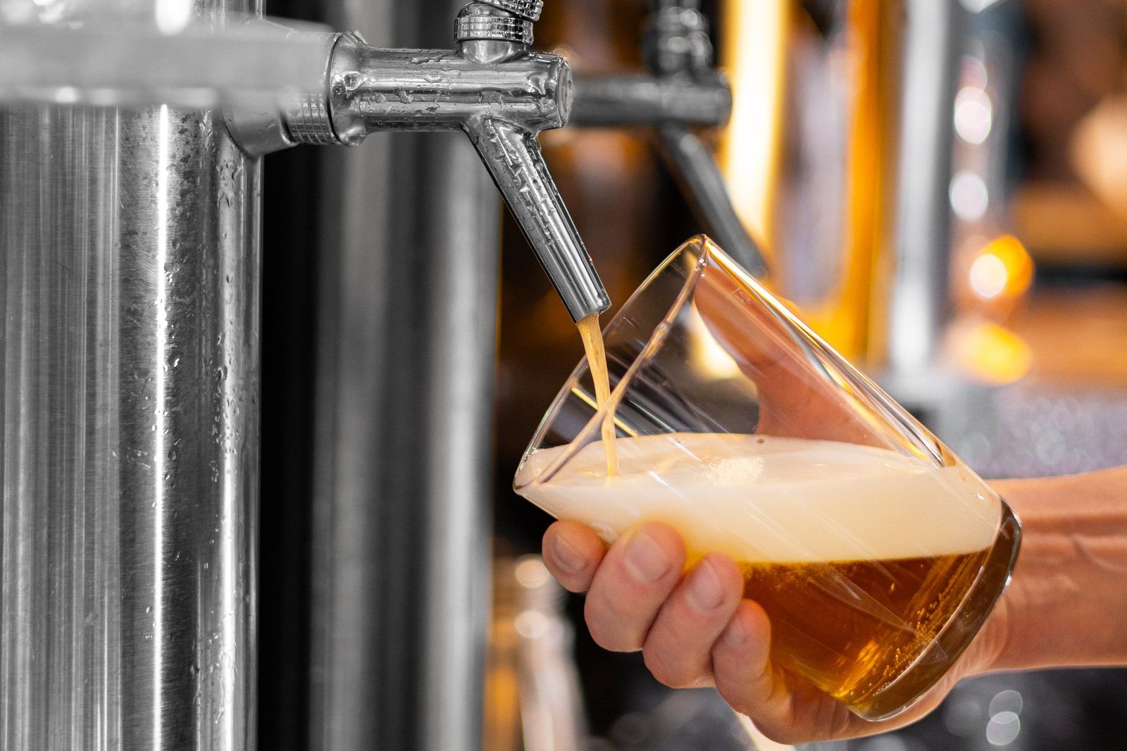 Beer poured from a tap into a glass.